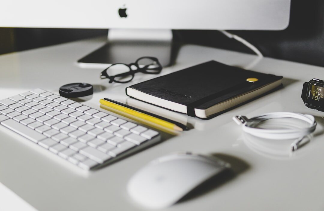 Organized desk with notebook, pen and laptop keyboard